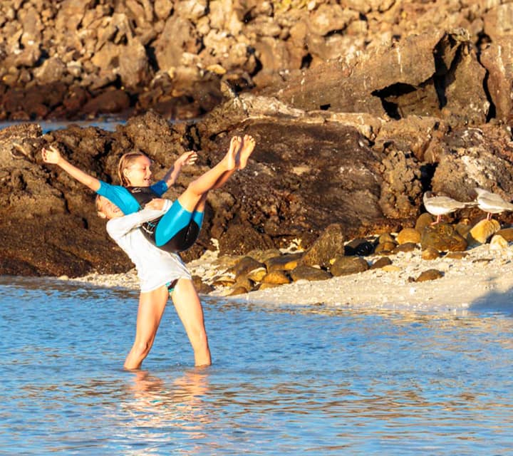 Kids having fun on a beach in the Galapagos