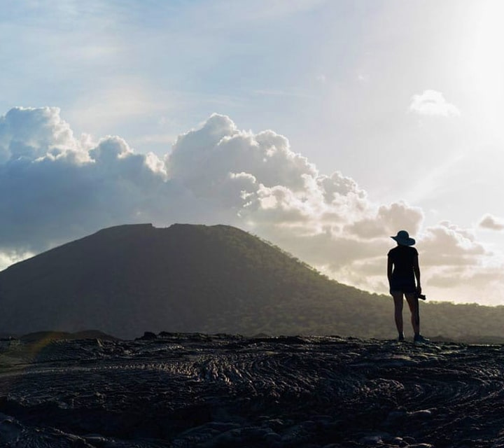 Hiker observing the lava fields on a trip to the Galapagos