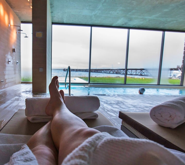 A man relaxing by the spa at a luxury hotel in Patagonia