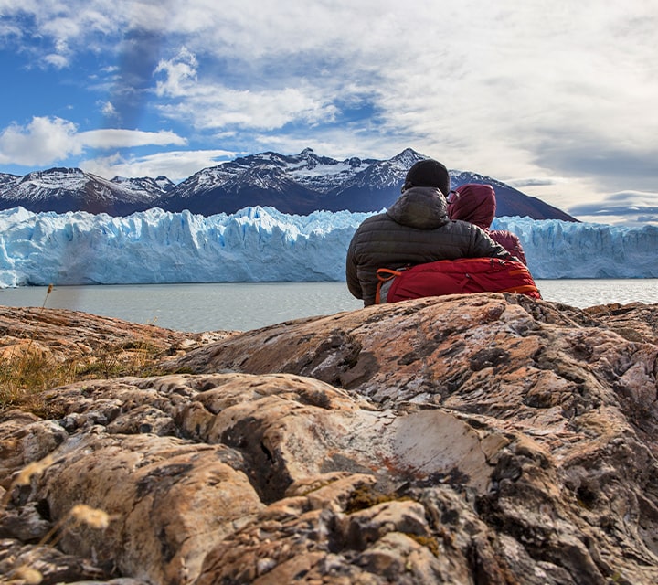 A couple at a vantage point looking at Perito Moreno Glacier in Patagonia