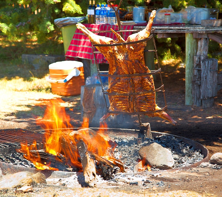Traditional Argentinean asado prepared outdoors for a culture rich experience for Patagonian guests