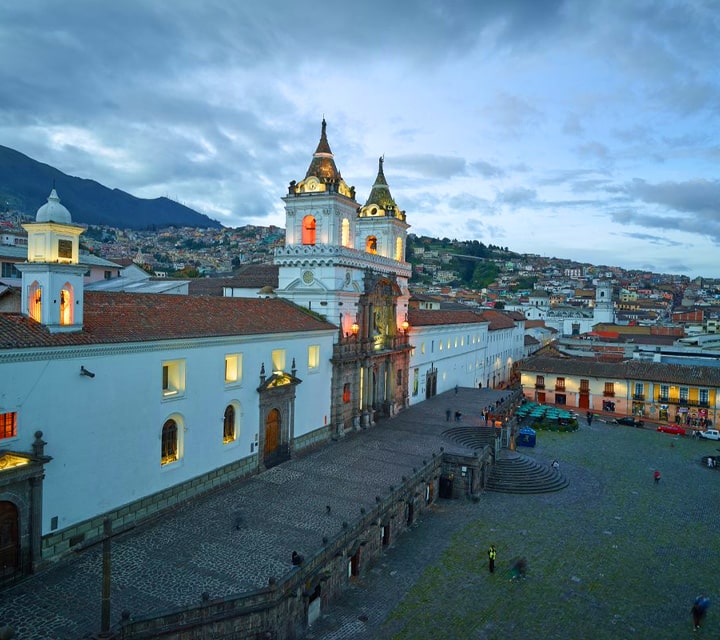 Colonial Quito in the evening with rolling hills in the background