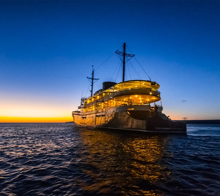The stern of the Evolution Yacht shown lit up in the Pacific Ocean, Galapagos Islands,Ecuador