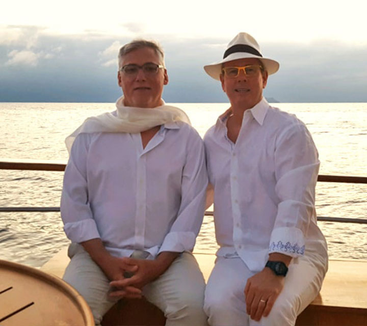Michael Murphy and his husband lounging aboard the privately chartered Grace Yacht by Quasar Expeditions