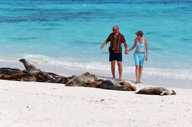 A couple walking on the beach in the Galapagos