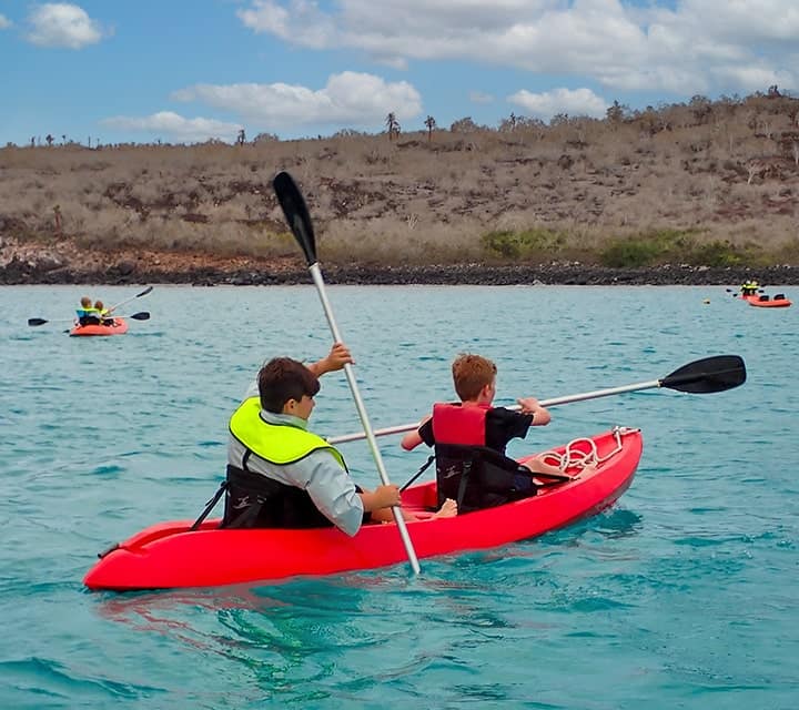 kids kayaking in the galapagos